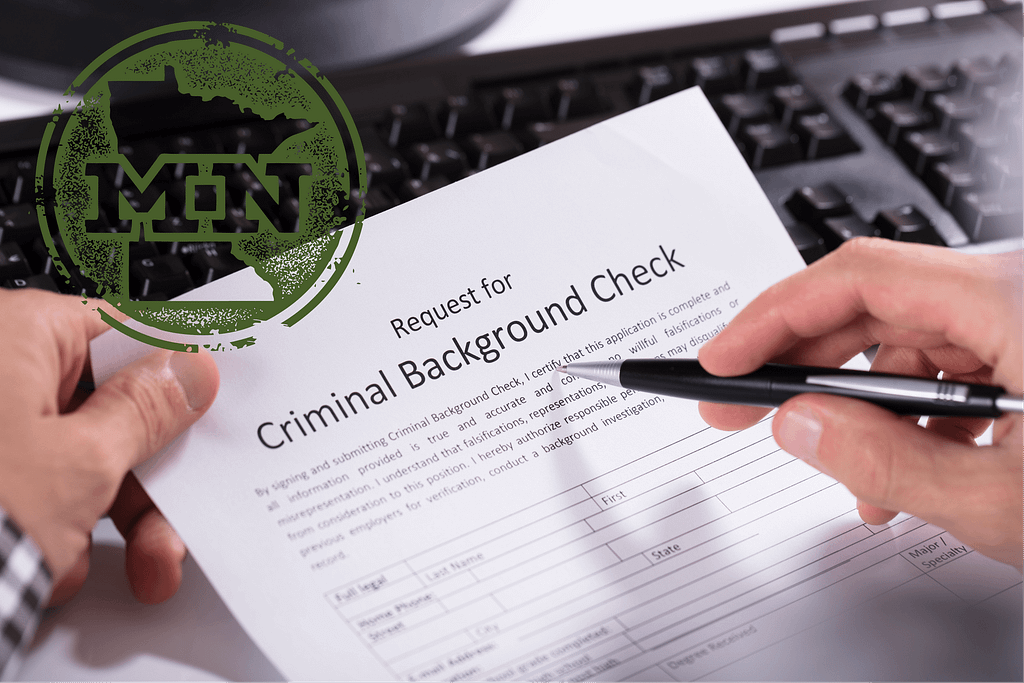 a person holding a pen over a paper